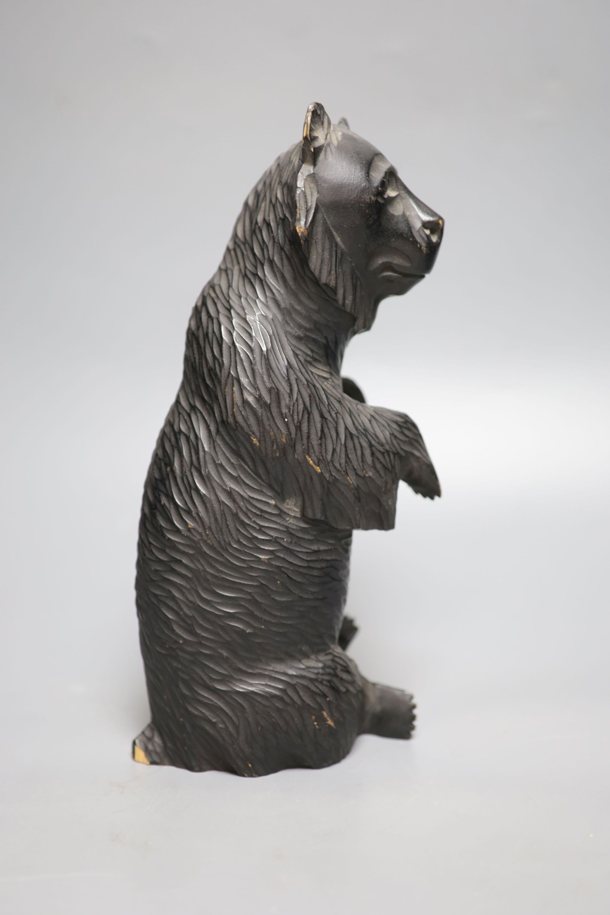 A Black Forest style carved bear, height 28cm